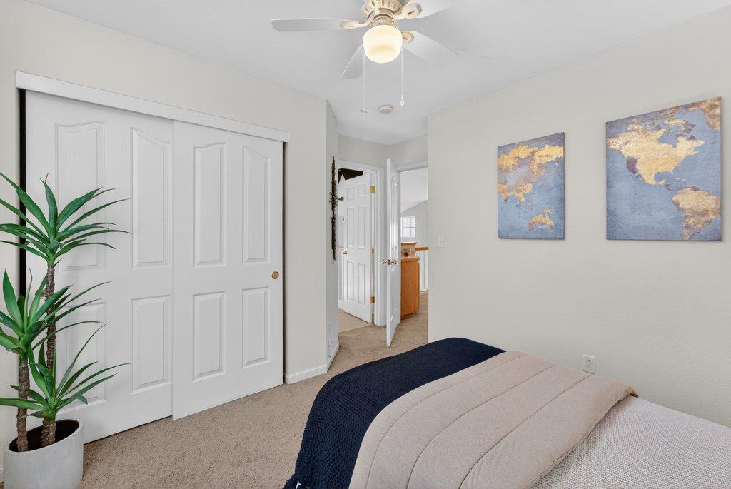 9336 Lariat Drive Gilroy, CA 95020 - Photo 28 of 41 a bedroom with a large bed and a chandelier