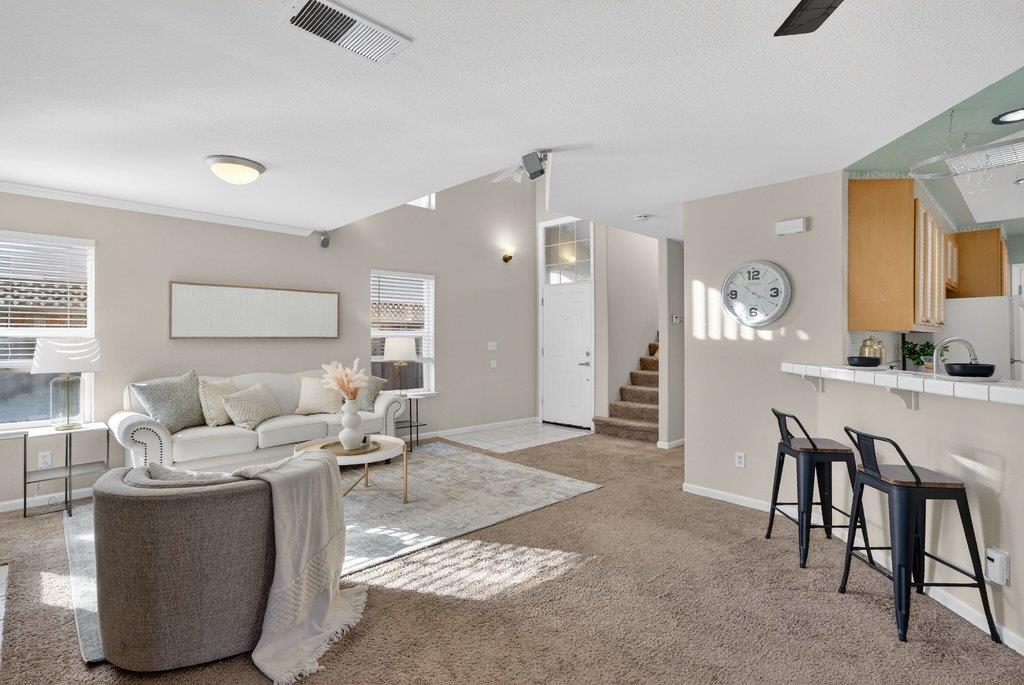 9336 Lariat Drive Gilroy, CA 95020 - Photo 8 of 41 a living room with furniture a clock and a view of kitchen