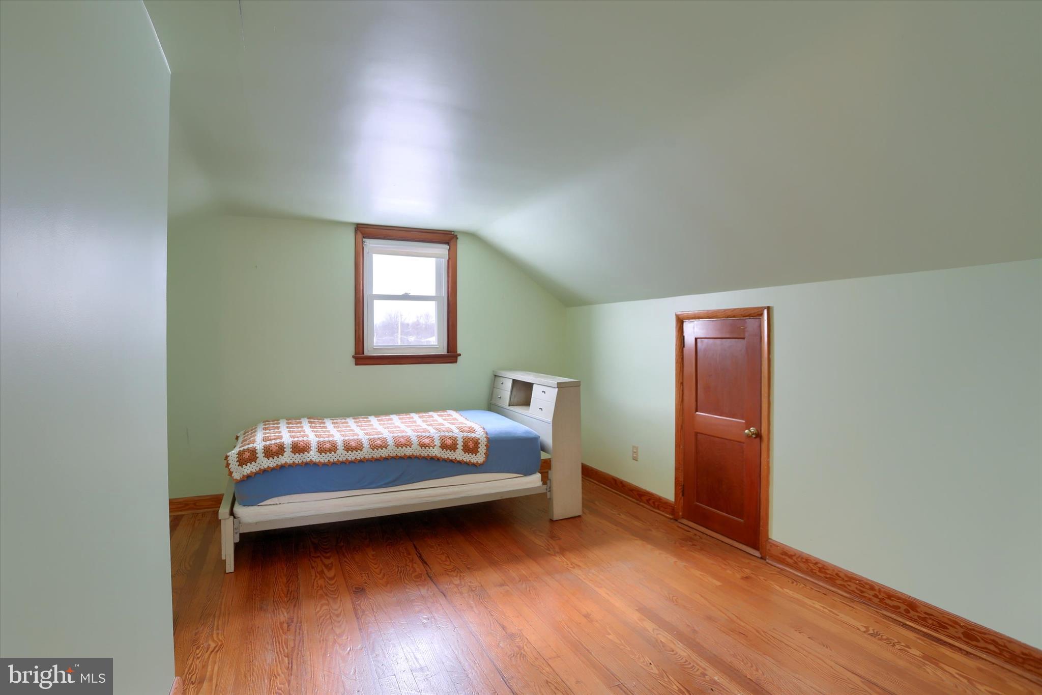 678 Littlestown Road Littlestown, PA 17340 - Photo 18 of 53 a bedroom with a bed and wooden floor
