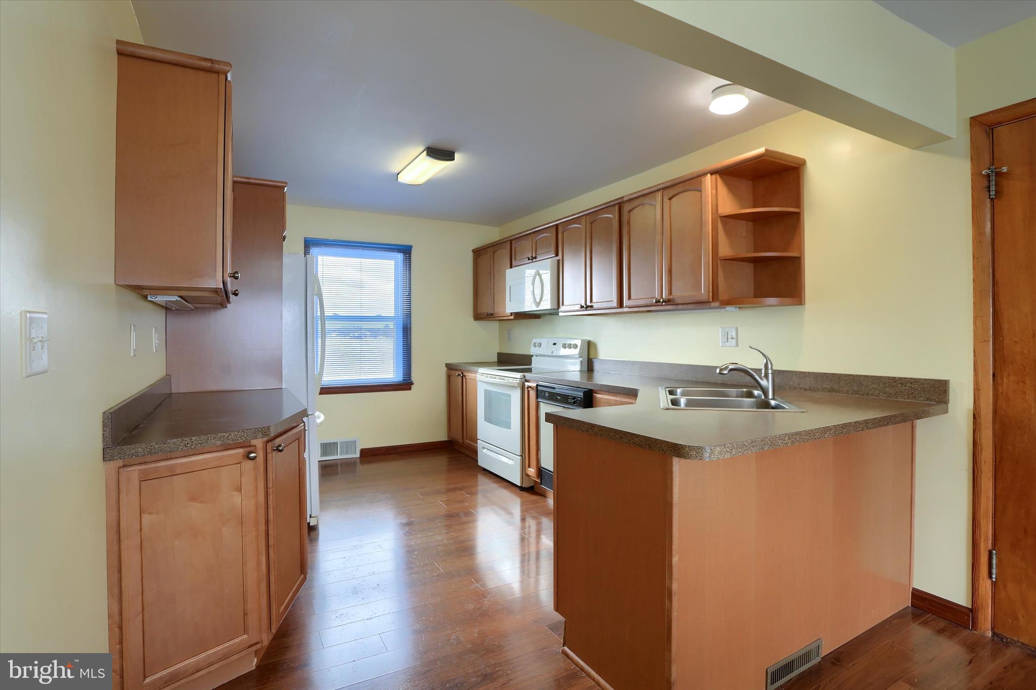 678 Littlestown Road Littlestown, PA 17340 - Photo 7 of 55 a kitchen with a sink stove top oven and cabinets