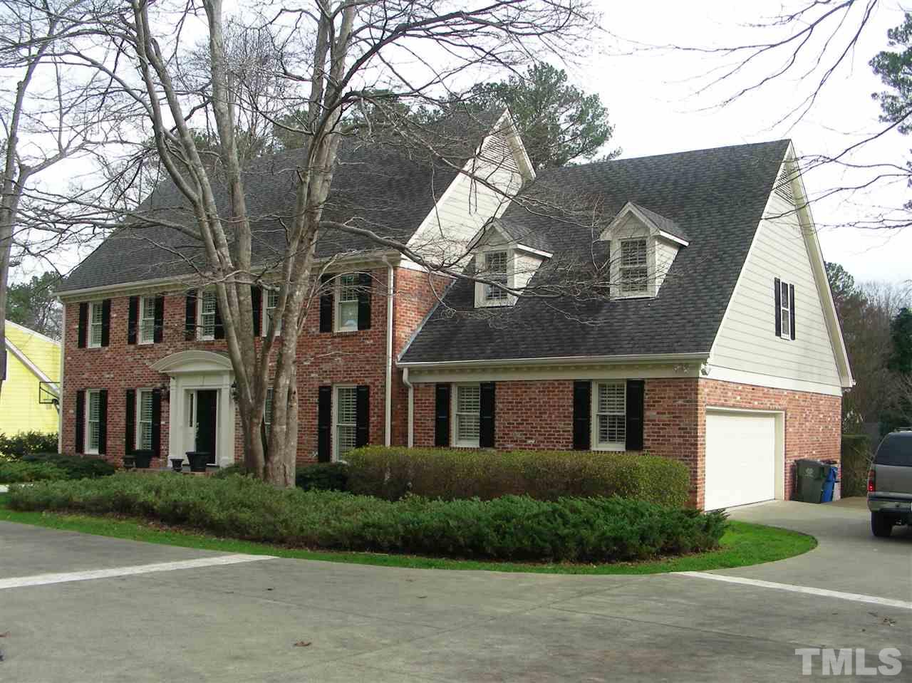 6904 North Ridge Drive Raleigh, NC 27615 - Photo 3 of 6 a view of a building next to a yard