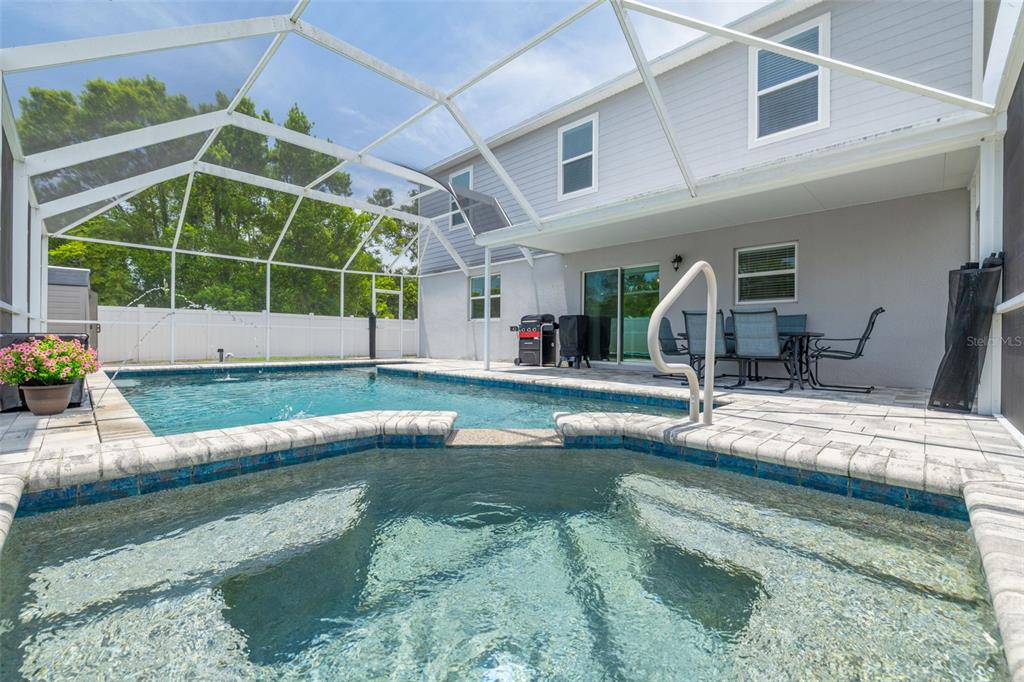 7242 Landmark Drive Spring Hill, FL 34606 - Photo 20 of 45 a view of pool with two windows and plants