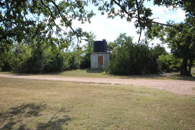 a front view of a house with a yard and table