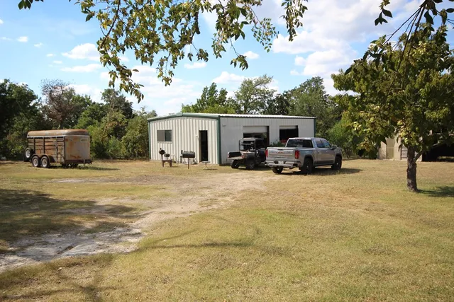 a view of a backyard with sitting area