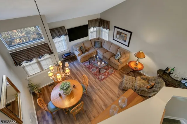 a view of a dining room with furniture a chandelier and window