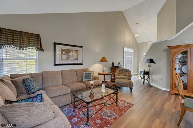 a view of a dining room with furniture and chandelier