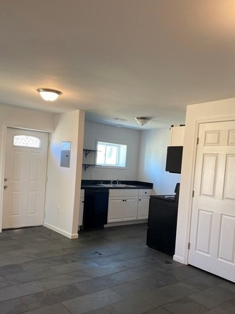 209 Neelys Bend Road, Unit B Madison, TN 37115 - Photo 4 of 11 a large kitchen with a refrigerator stove and wooden floor