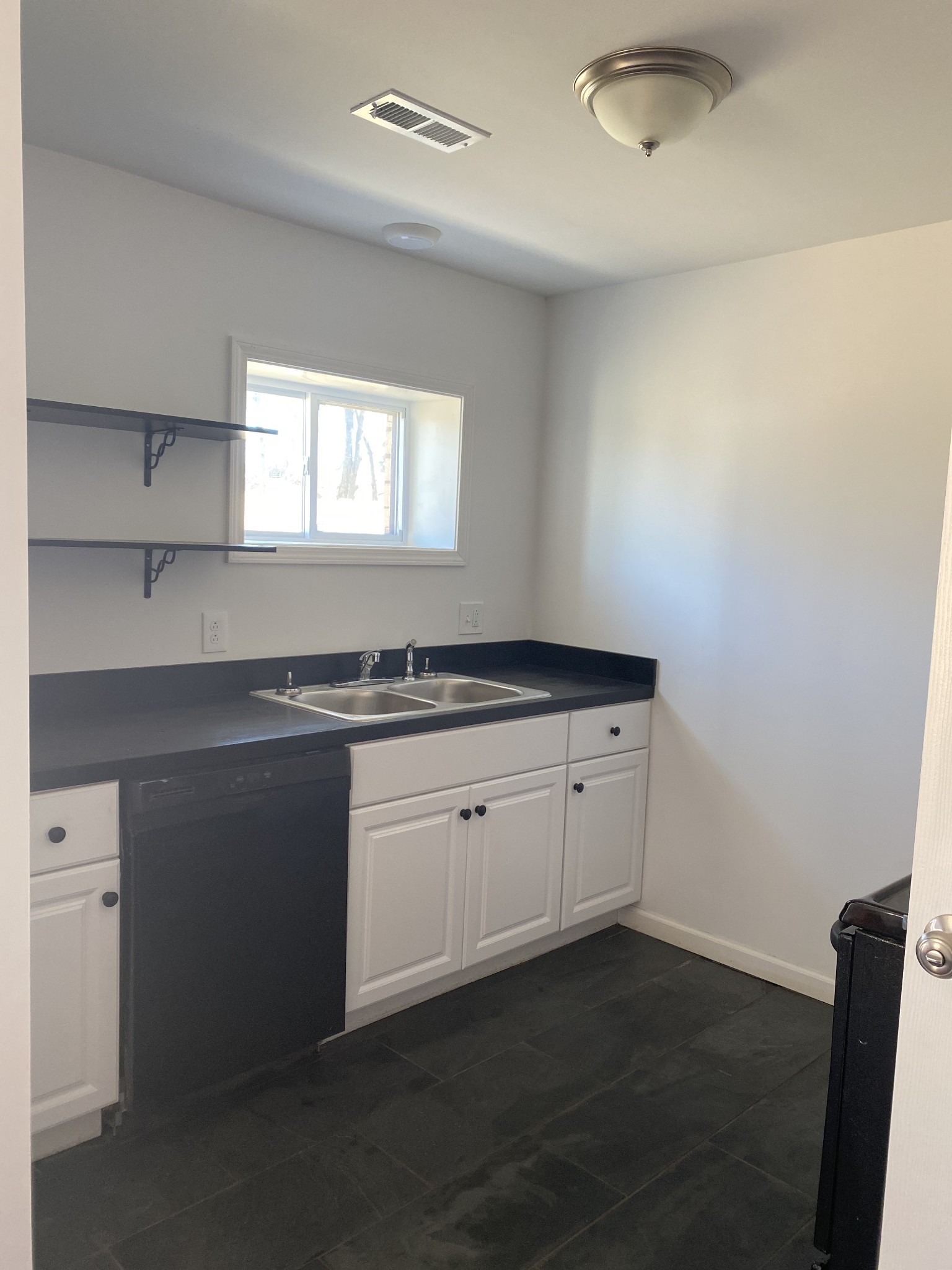 209 Neelys Bend Road, Unit B Madison, TN 37115 - Photo 5 of 11 a kitchen with granite countertop white cabinets and a granite counter tops