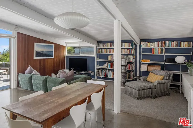 a living room with a large window and table