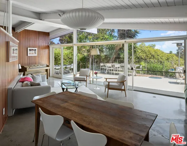 a spacious bedroom with a large bed and a large window