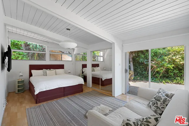 a bed room with a bed and a large window