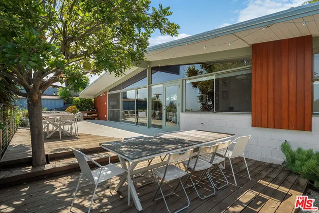 a view of a patio with couches and a fire pit
