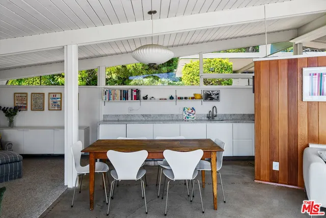 a kitchen with stainless steel appliances granite countertop a refrigerator a stove and a sink