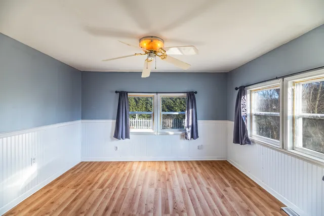 a view of a room with a window and wooden floor