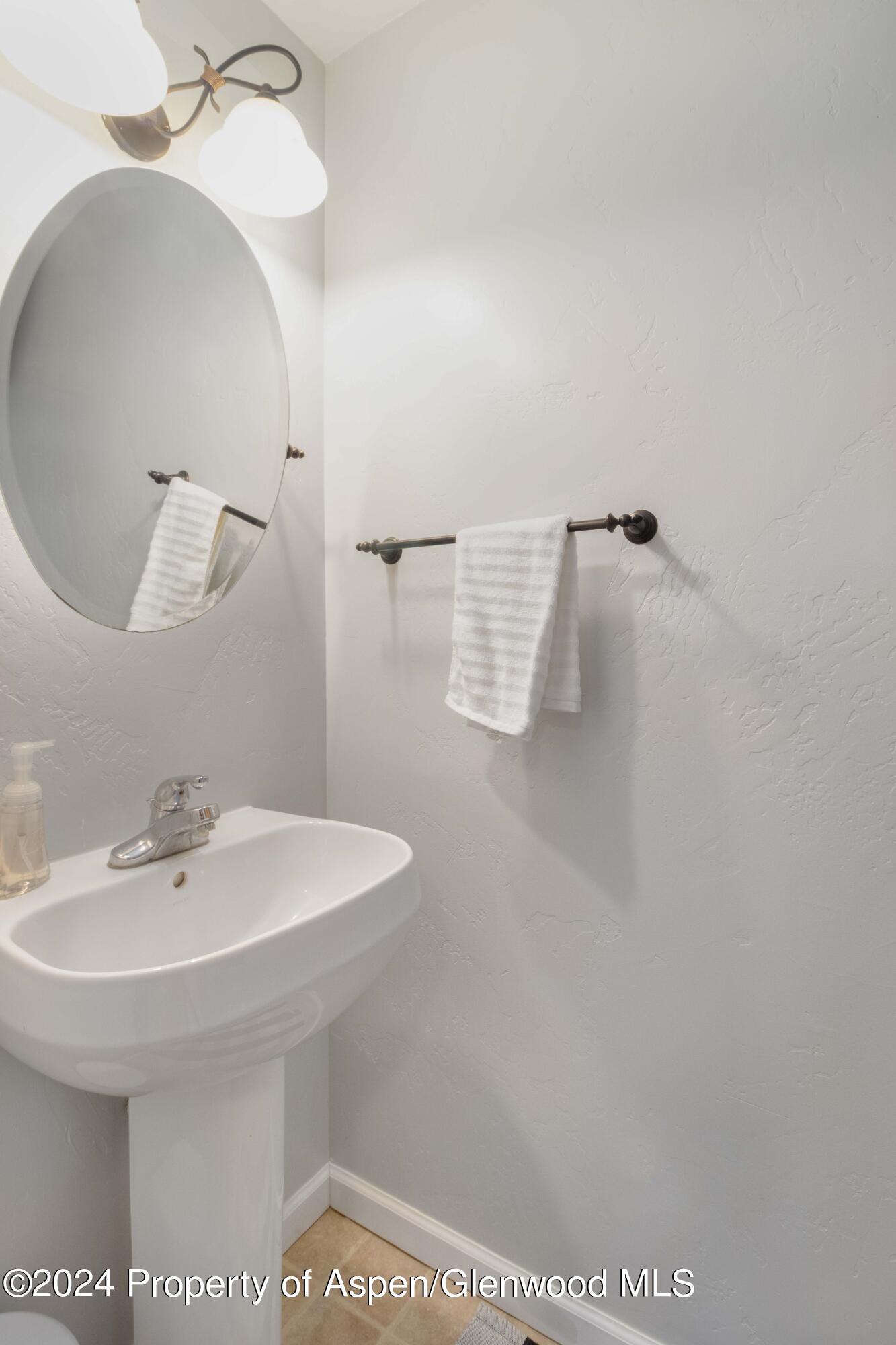 783 East 19th Street Rifle, CO 81650 - Photo 11 of 21 a bathroom with a sink and mirror