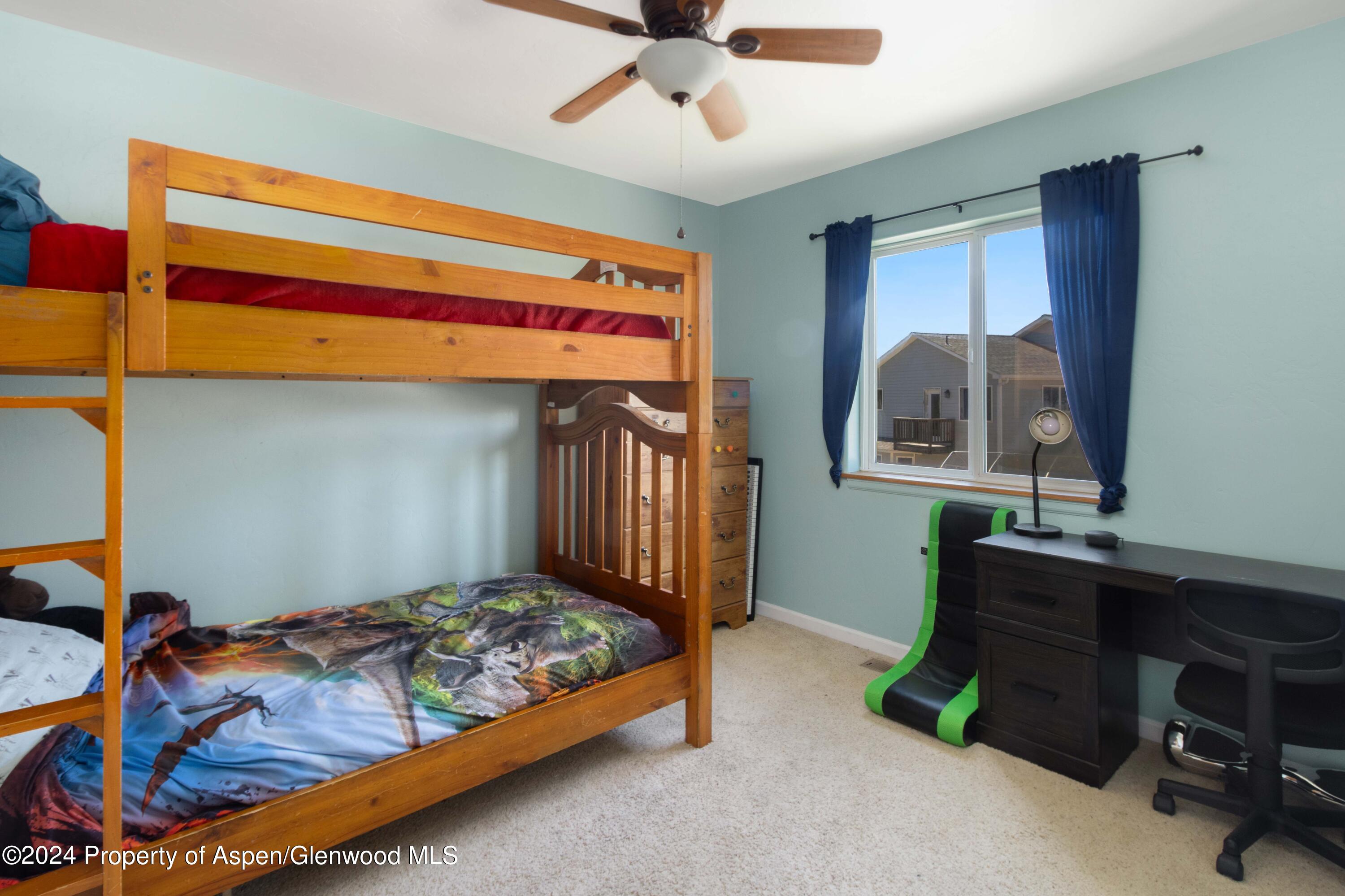 783 East 19th Street Rifle, CO 81650 - Photo 16 of 21 a bedroom with a bed and a chandelier