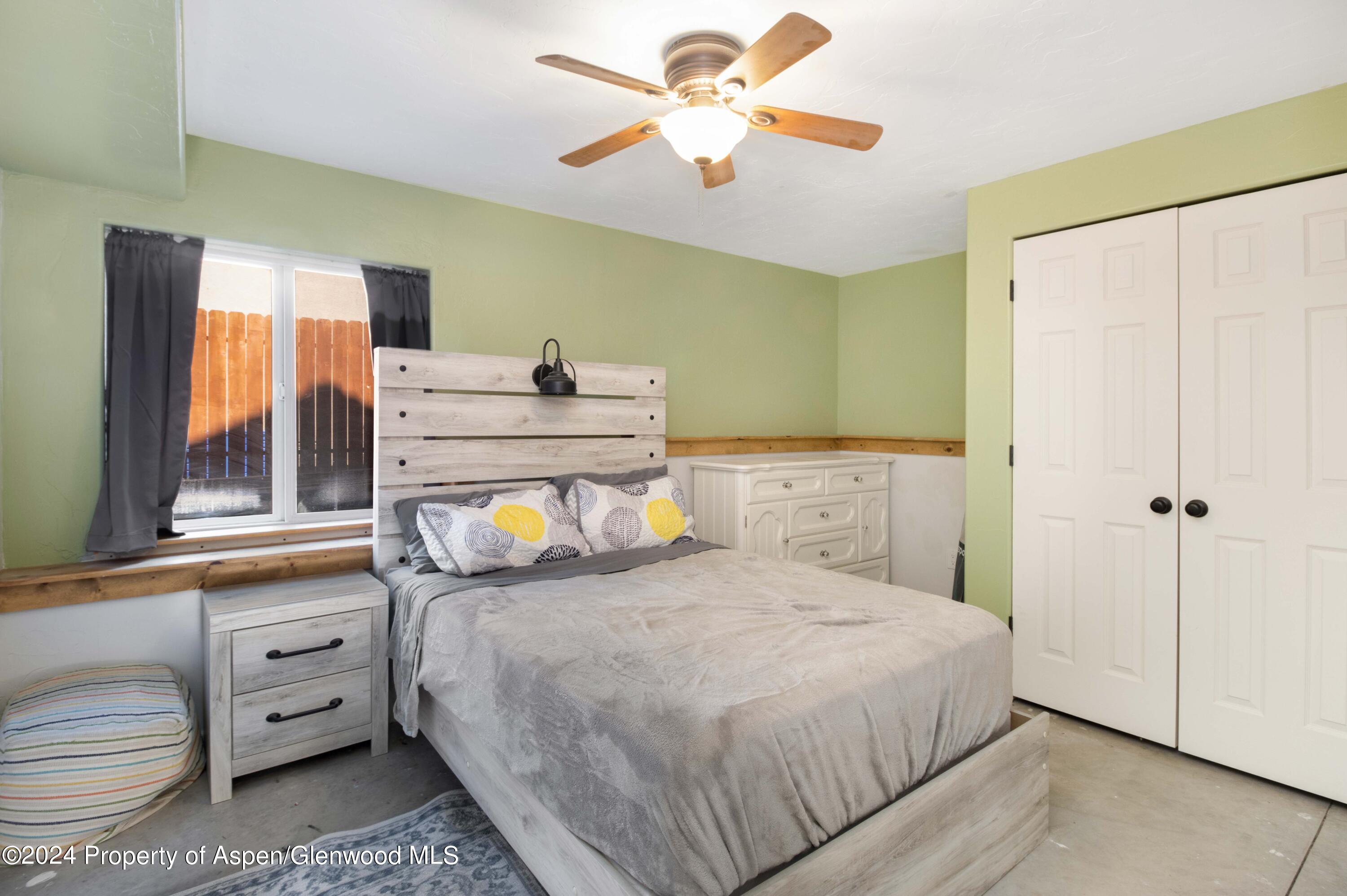 783 East 19th Street Rifle, CO 81650 - Photo 18 of 21 a bedroom with a bed and a chandelier