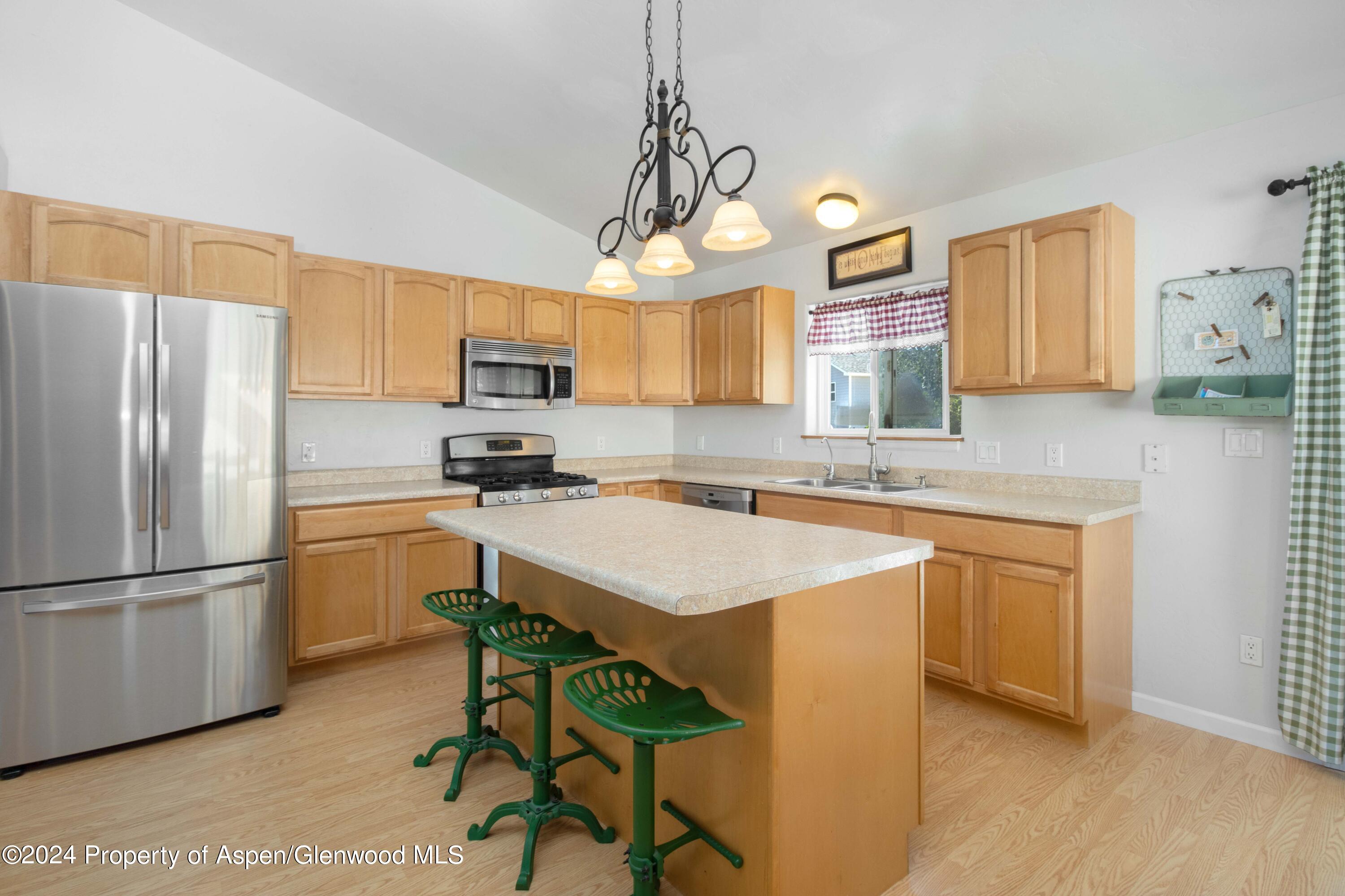 783 East 19th Street Rifle, CO 81650 - Photo 9 of 21 a kitchen with a refrigerator a sink dishwasher a stove and a refrigerator