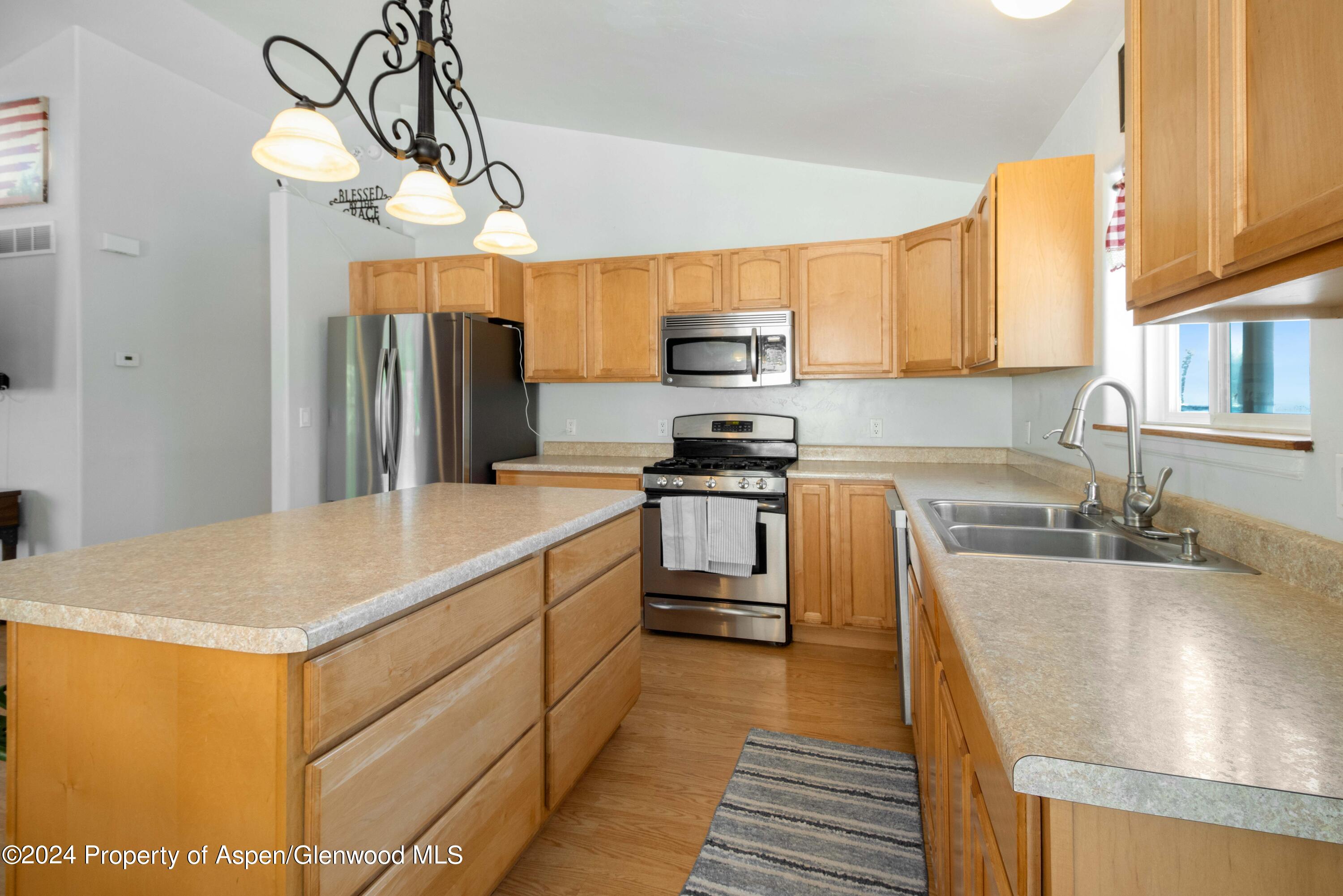 783 East 19th Street Rifle, CO 81650 - Photo 10 of 21 a kitchen with stainless steel appliances granite countertop a sink a stove and refrigerator