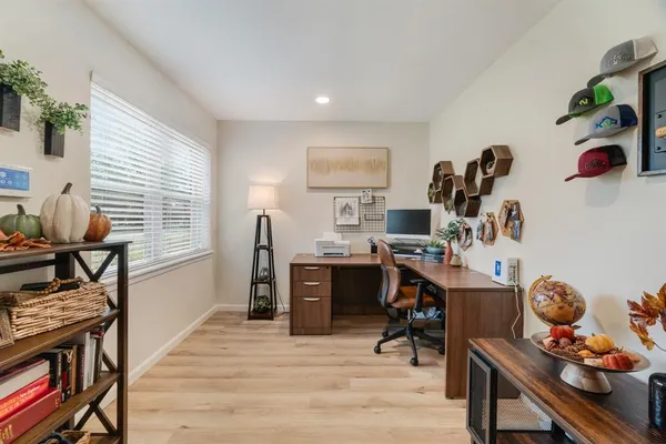 a living room with furniture and wooden floor