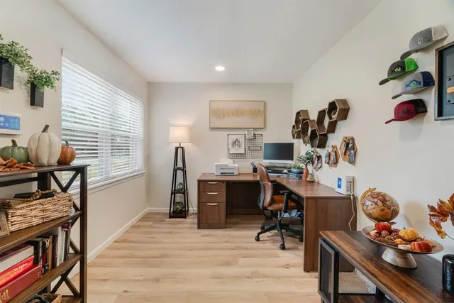 a living room with furniture and wooden floor