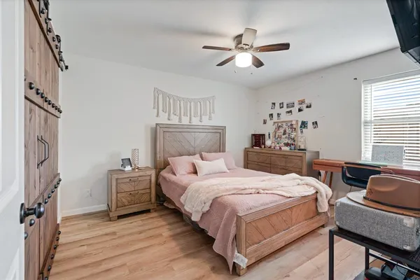 a bedroom with a bed and a chandelier