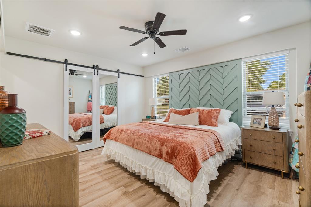 3276 Cleveland Street Paris, TX 75460 - Photo 16 of 31 a bedroom with a bed and a chandelier