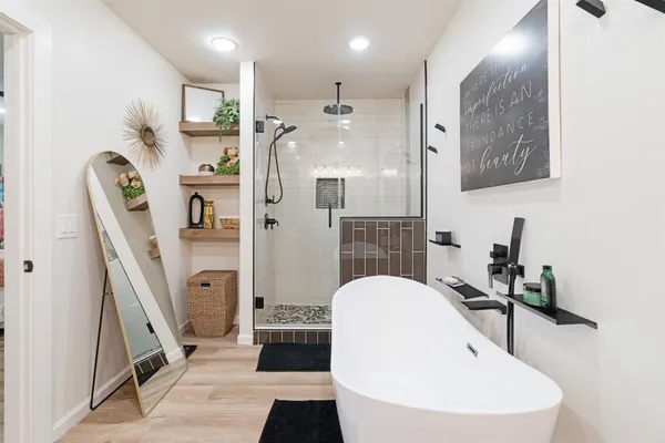 a bathroom with a sink a mirror and a shower