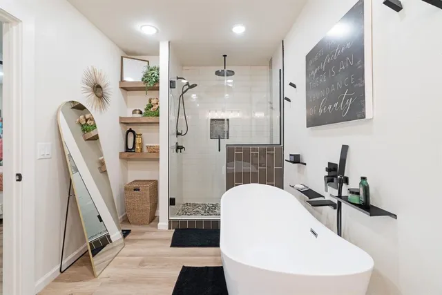 a bathroom with a sink a mirror and a shower