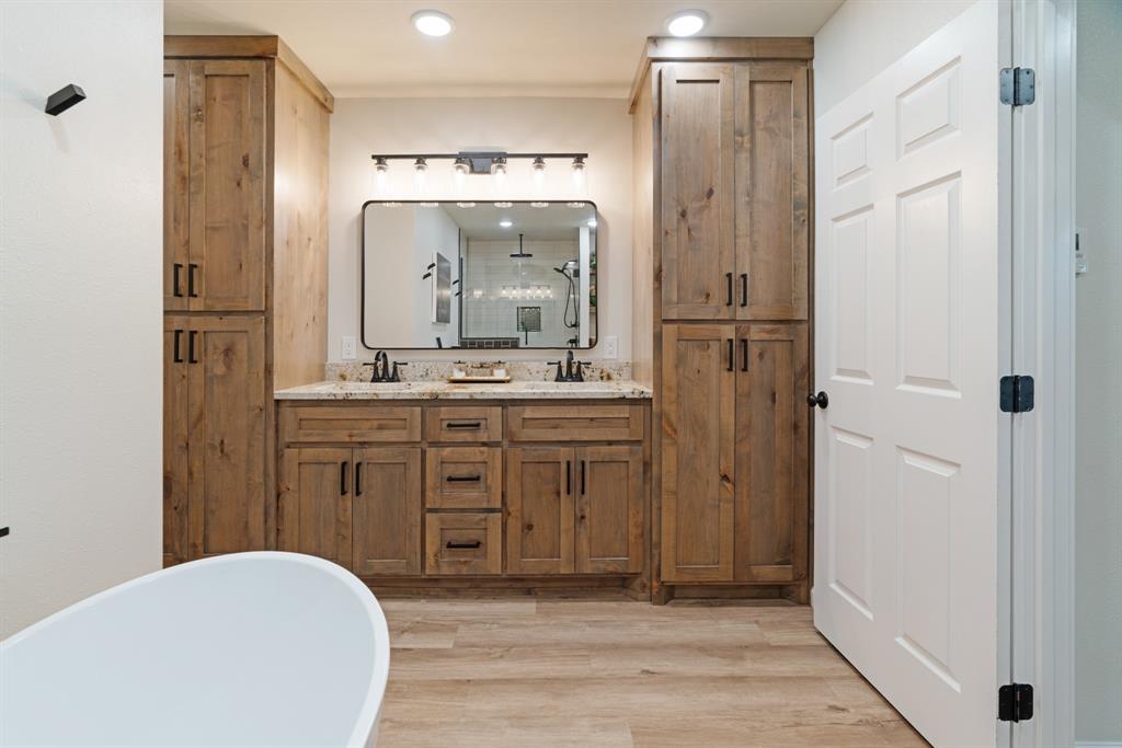 3276 Cleveland Street Paris, TX 75460 - Photo 18 of 31 a bathroom with a sink a mirror and a shower