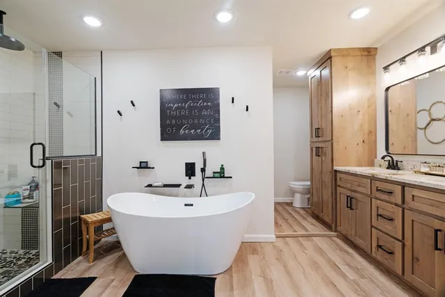 a large white kitchen with stainless steel appliances stove a sink and dishwasher