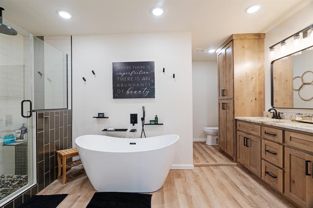 3276 Cleveland Street Paris, TX 75460 - Photo 19 of 31 a spacious bathroom with a sink mirror and shower