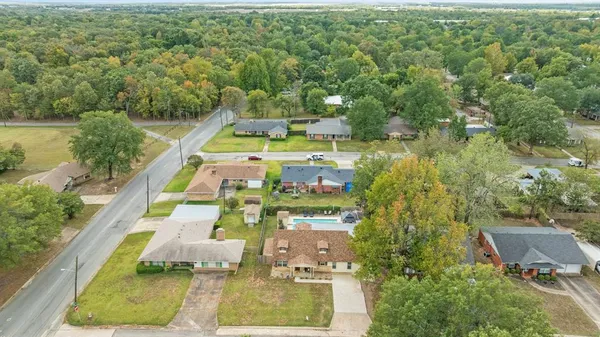 an aerial view of a residential houses with outdoor space