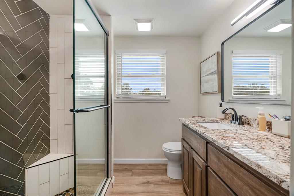 3276 Cleveland Street Paris, TX 75460 - Photo 24 of 31 a bathroom with a granite countertop sink toilet and shower