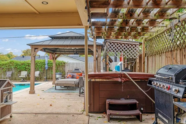 a swimming pool with outdoor seating and yard