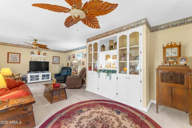 a view of a dining room with furniture a chandelier and wooden floor