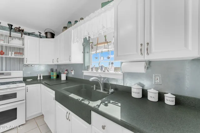 a bedroom with a bed and glass walk in closet