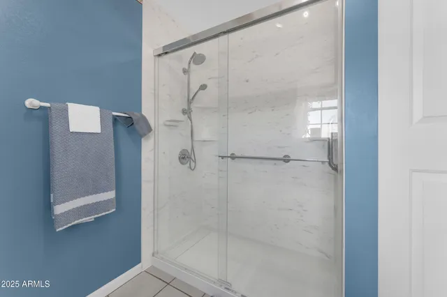 en empty room with windows and ceiling fan