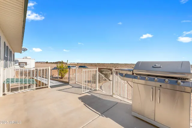 a view of a patio with couches table and chairs and potted plants
