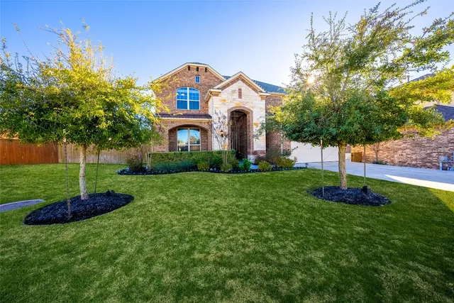 a front view of a house with a yard