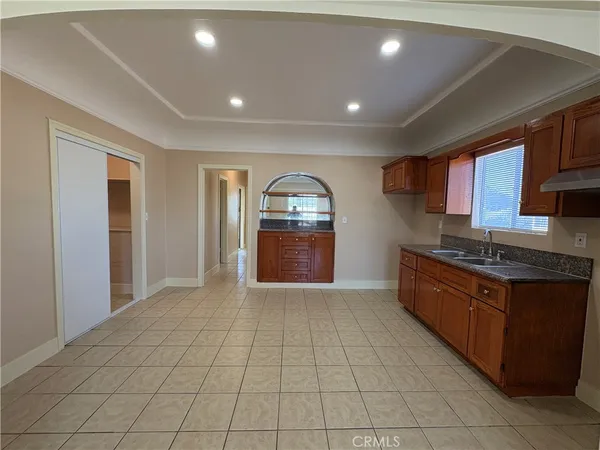 a kitchen with stainless steel appliances a stove a sink and a refrigerator