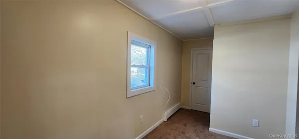 a view of an empty room with windows