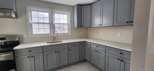 a kitchen with white cabinets and a sink