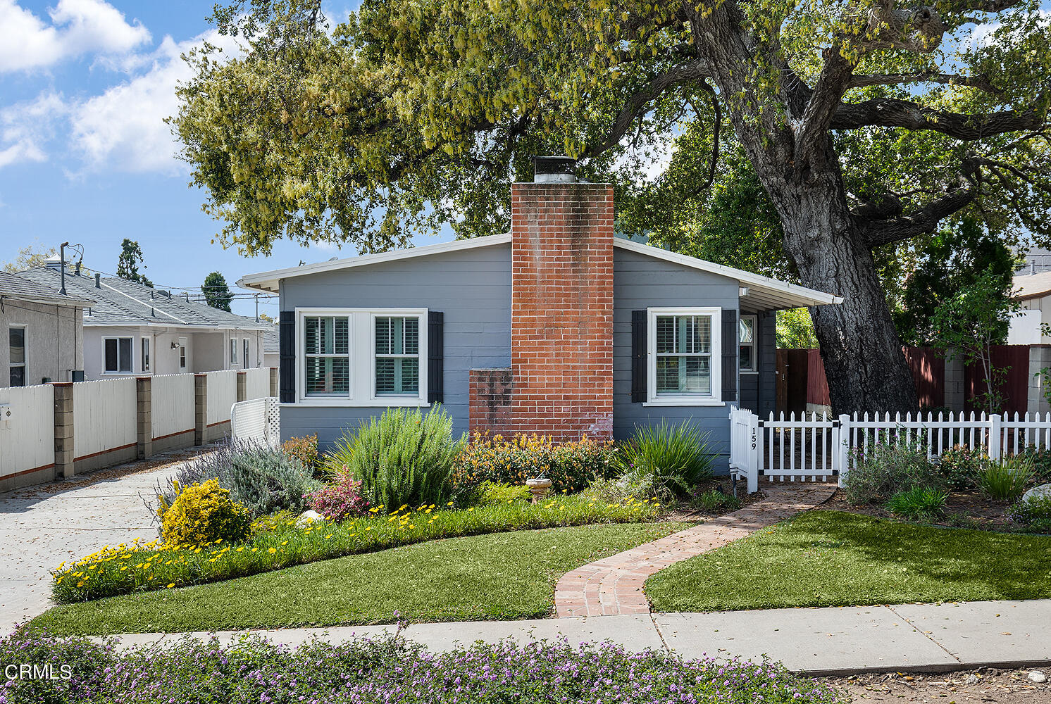 159-161 May Avenue Monrovia, CA 91016 - Photo 1 of 33 a front view of a house with a garden