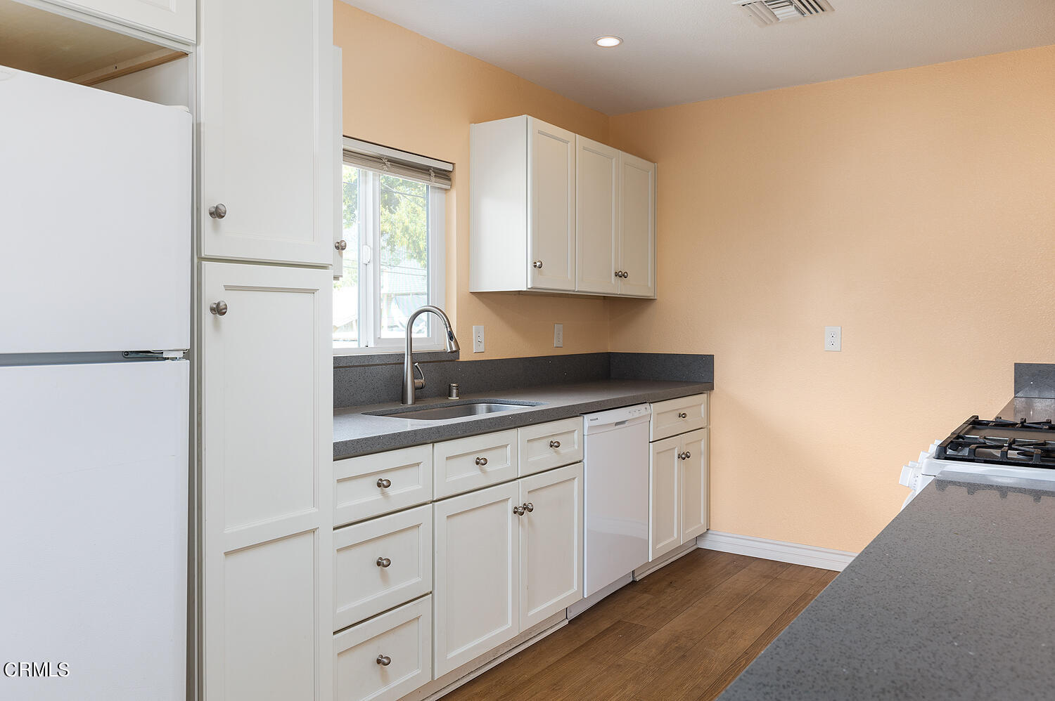 159-161 May Avenue Monrovia, CA 91016 - Photo 23 of 33 a kitchen with granite countertop white cabinets and white appliances
