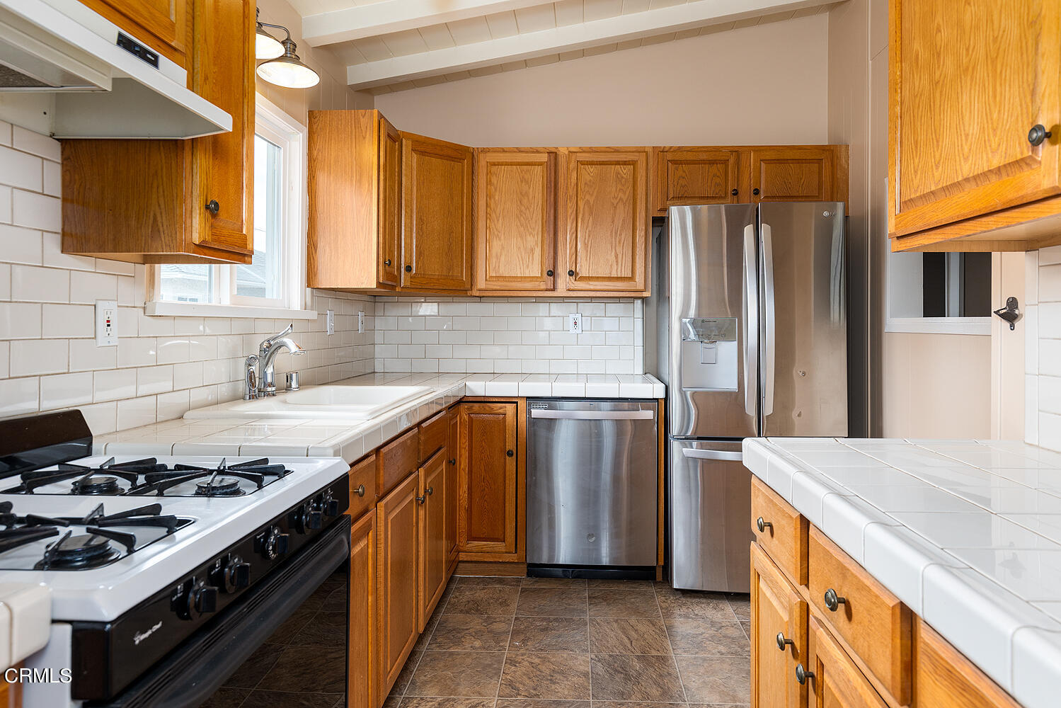 159-161 May Avenue Monrovia, CA 91016 - Photo 8 of 33 a kitchen with a stove a sink and a refrigerator
