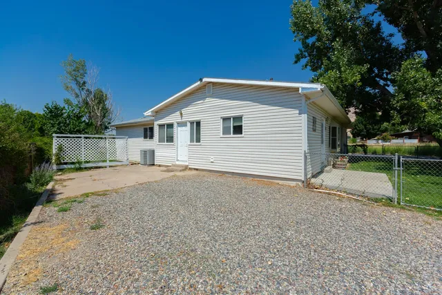a backyard of a house with plants and trees
