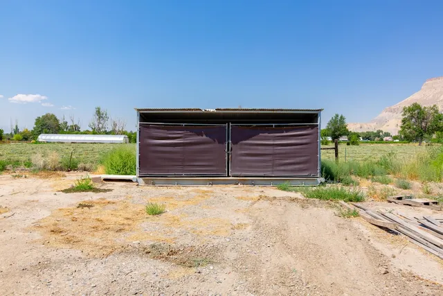 a view of a grassy field with mountains in the background