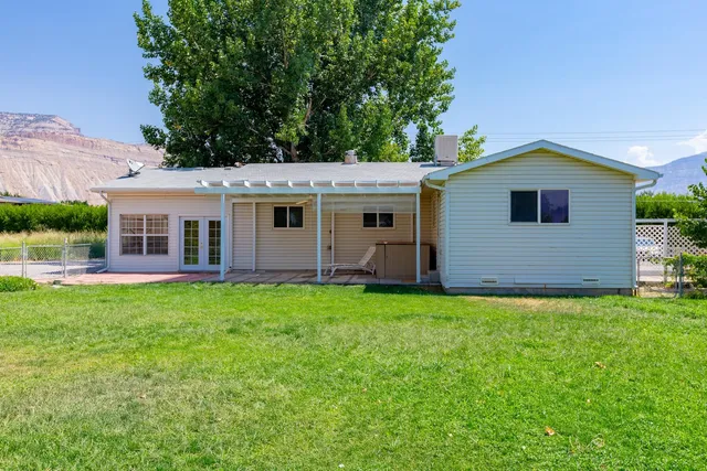 a view of a patio with a table chairs and a backyard