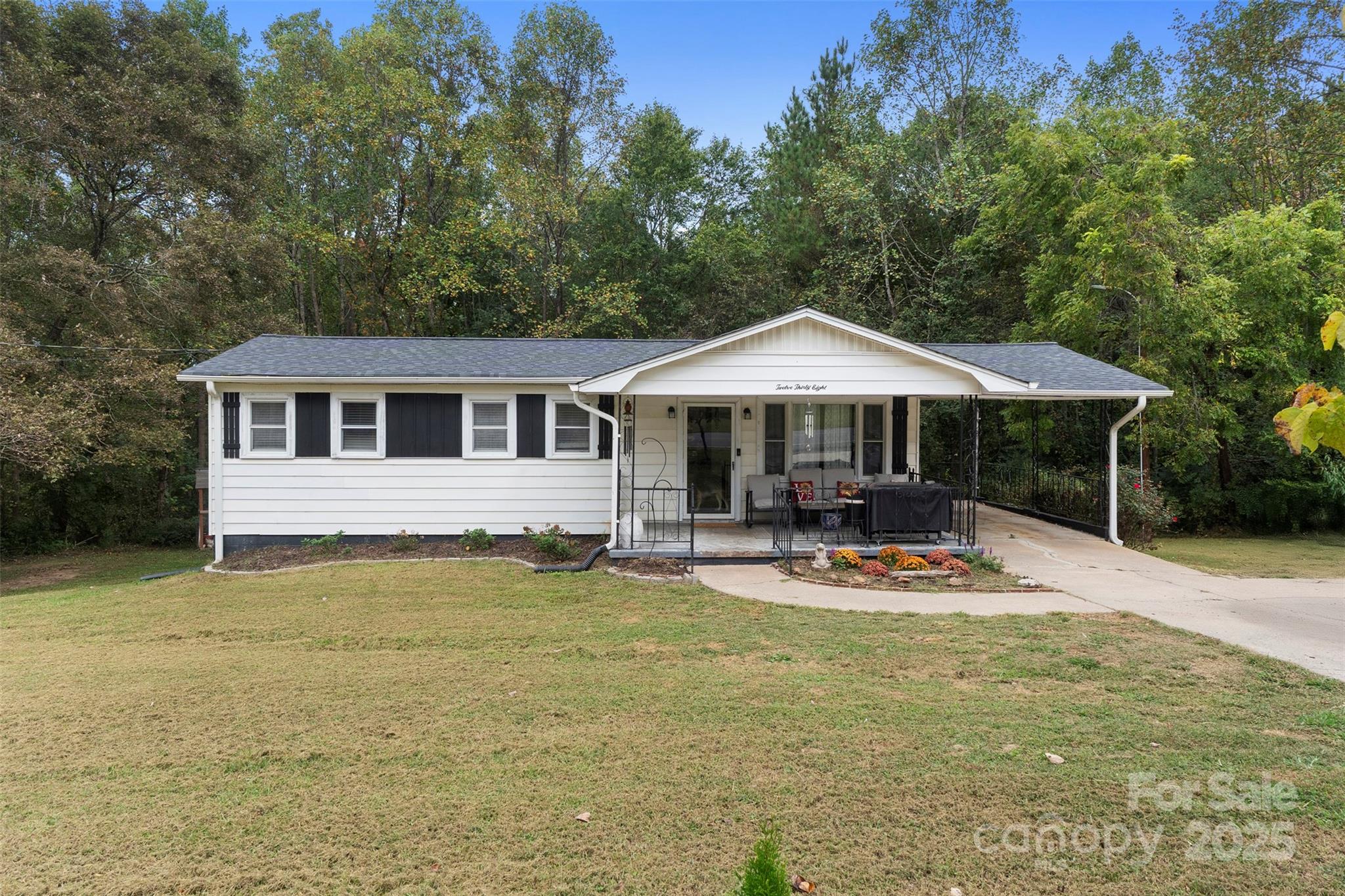 a view of a swimming pool with lawn chairs under an umbrella